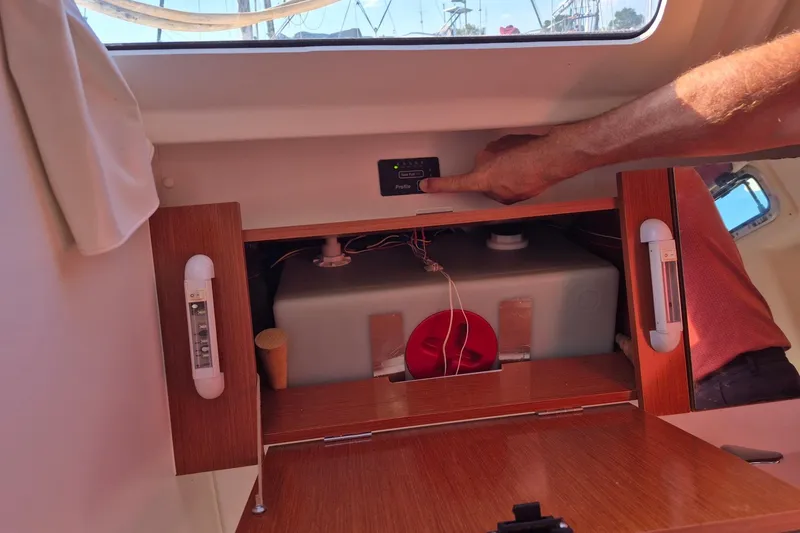 Slide: The Image of Interior of 2011 Beneteau Oceanis 37 showing control panel and storage compartment. - 33