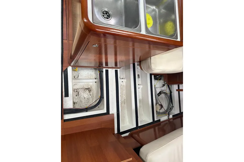 Slide: The Image of Interior view of 2011 Beneteau Oceanis 37 yacht, featuring a dual sink and storage compartments. - 37