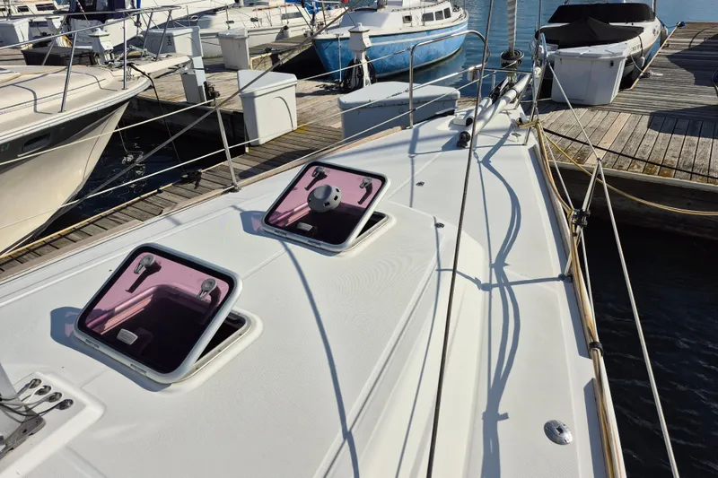 Slide: The Image of 2011 Beneteau Oceanis 37 sailboat deck with open hatches at marina. - 5