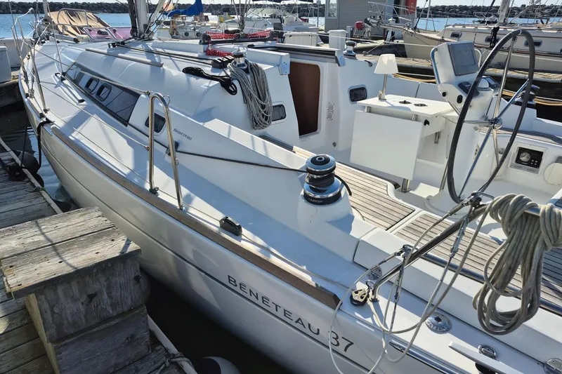 Slide: The Image of 2011 Beneteau Oceanis 37 sailboat docked, showcasing deck and cockpit details. - 8