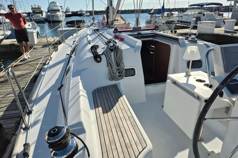 Slide: The Image of 2011 Beneteau Oceanis 37 sailboat docked at marina, featuring spacious deck and cockpit. - 9