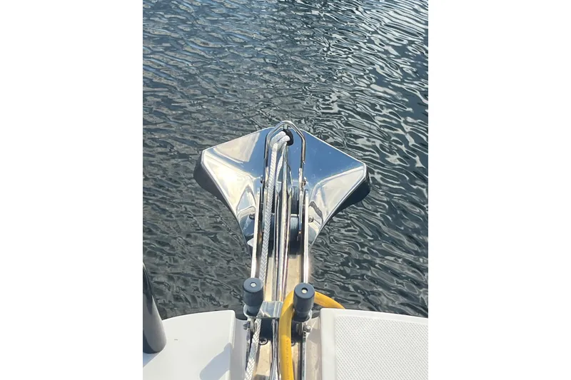 Slide: The Image of Bow of 2021 Axopar 37 Cross Cabin boat with anchor over water. - 15