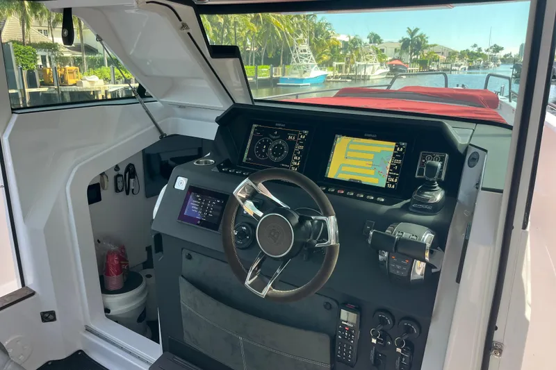 Slide: The Image of 2021 Axopar 37 Cross Cabin helm with modern navigation displays and controls. - 22