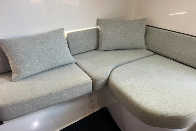 Slide: The Image of Gray cushioned seating in 2021 Axopar 37 Cross Cabin interior. - 24