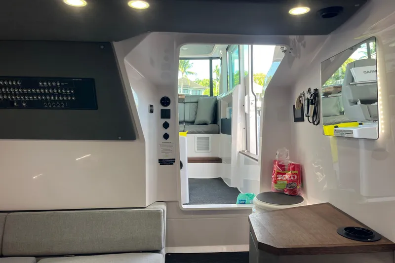 Slide: The Image of Interior of 2021 Axopar 37 Cross Cabin boat, featuring modern seating and control panel. - 25