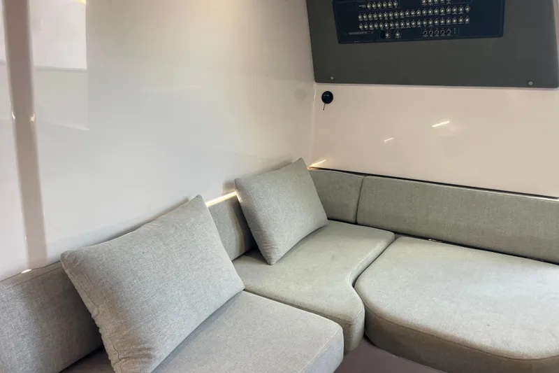 Slide: The Image of Interior of 2021 Axopar 37 Cross Cabin with gray seating and control panel. - 26