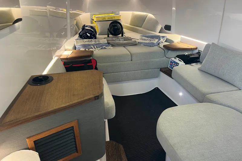 Slide: The Image of Interior of 2021 Axopar 37 Cross Cabin with cozy seating and nautical decor. - 29