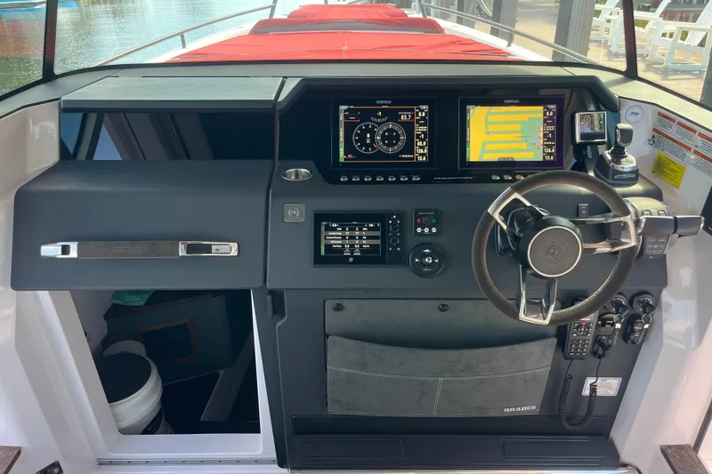 Slide: The Image of 2021 Axopar 37 Cross Cabin helm with advanced navigation displays and controls. - 30