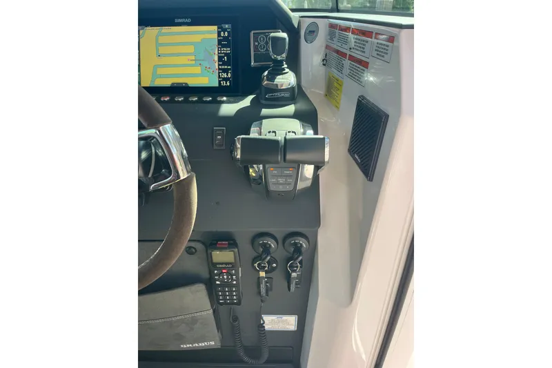 Slide: The Image of 2021 Axopar 37 Cross Cabin helm with Simrad display and controls. - 34