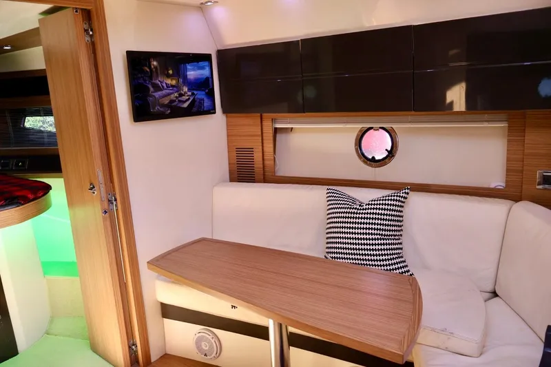 Slide: The Image of Luxurious interior of a 2014 Azimut 38 yacht with modern furnishings and a cozy seating area. - 15