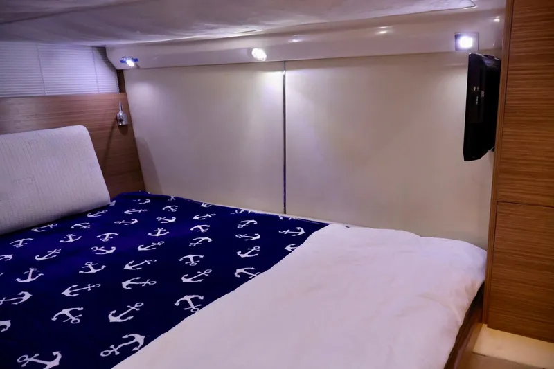 Slide: The Image of Cozy bedroom interior of 2014 Azimut 38 yacht with anchor-themed bedding. - 18