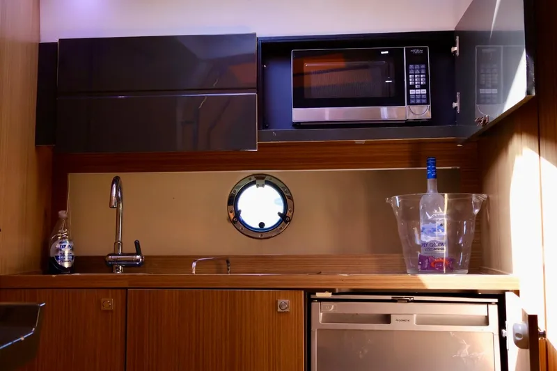 Slide: The Image of Compact kitchen area in a 2014 Azimut 38 yacht with microwave and sink. - 22