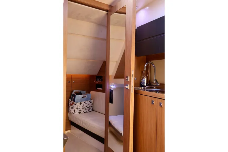 Slide: The Image of Luxurious interior of 2014 Azimut 38 yacht featuring cozy cabin and kitchenette. - 23