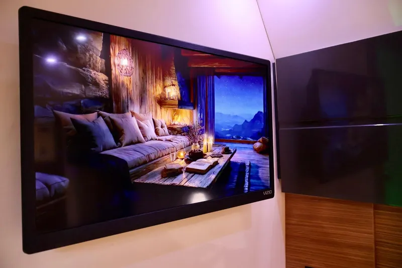 Slide: The Image of Flat-screen TV displaying cozy living room scene on Azimut 38 yacht, 2014 model. - 25