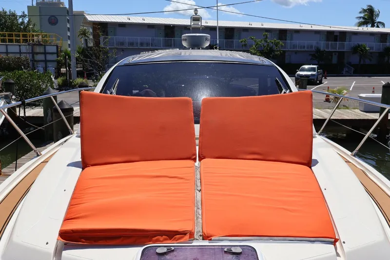 Slide: The Image of 2014 Azimut 38 yacht with orange sun loungers on deck, docked at marina. - 30