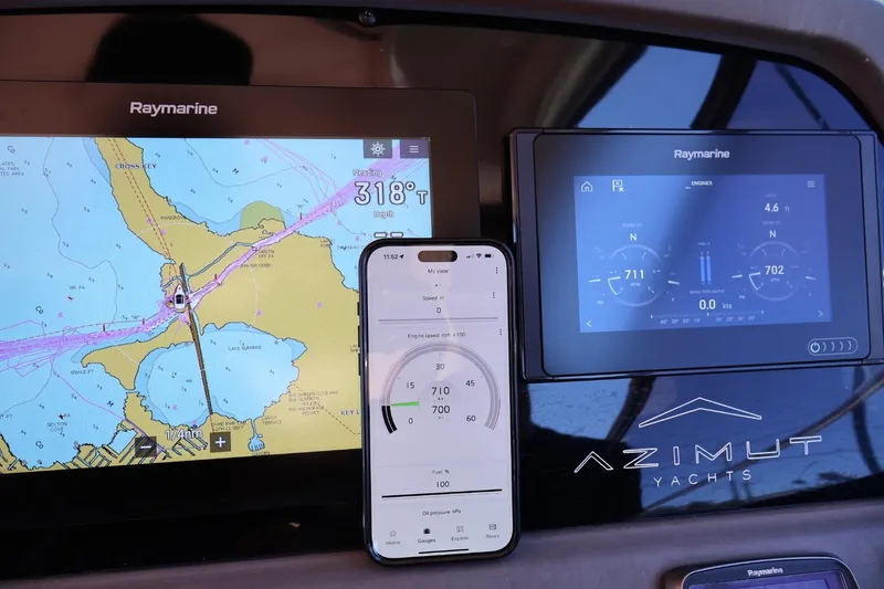 Slide: The Image of Navigation and engine displays on a 2014 Azimut 38 yacht dashboard. - 32
