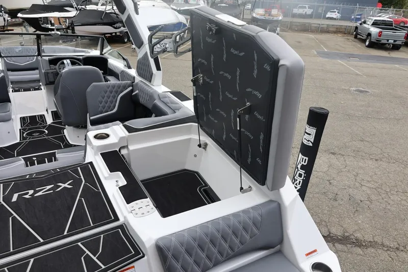 Slide: The Image of 2026 Tigé 22RZX boat interior with open storage compartment and luxury seating. - 18