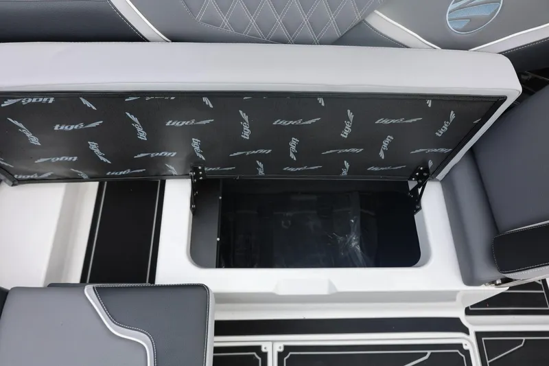 Slide: The Image of 2026 Tigé 22RZX boat storage compartment with open seat and sleek interior design. - 26