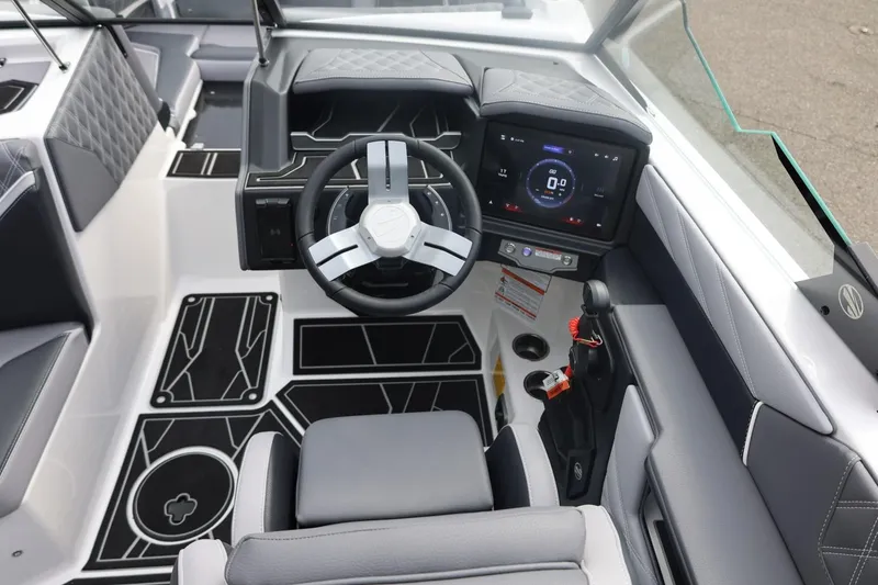 Slide: The Image of 2026 Tigé 22RZX boat interior with modern steering wheel and digital dashboard display. - 31