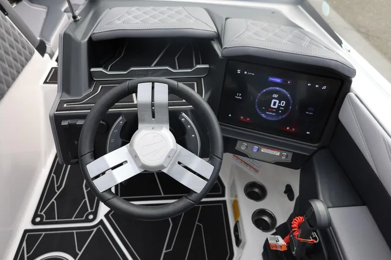 Slide: The Image of 2026 Tigé 22RZX boat dashboard with modern steering wheel and digital display. - 32