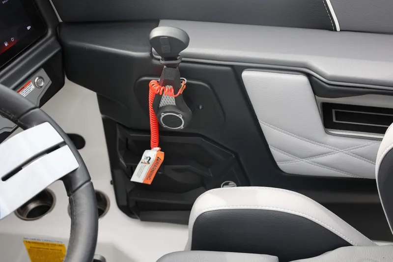 Slide: The Image of Interior of 2026 Tigé 22RZX boat, featuring steering wheel and safety lanyard. - 33
