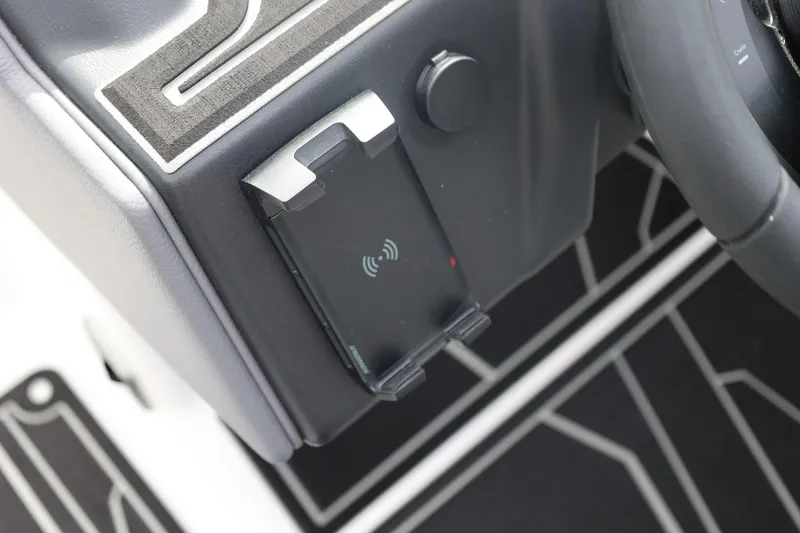 Slide: The Image of 2026 Tigé 22RZX dashboard with wireless charging pad and steering wheel detail. - 34