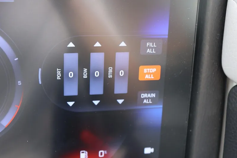 Slide: The Image of Close-up of 2026 Tigé 22RZX control panel with fill and drain options. - 38