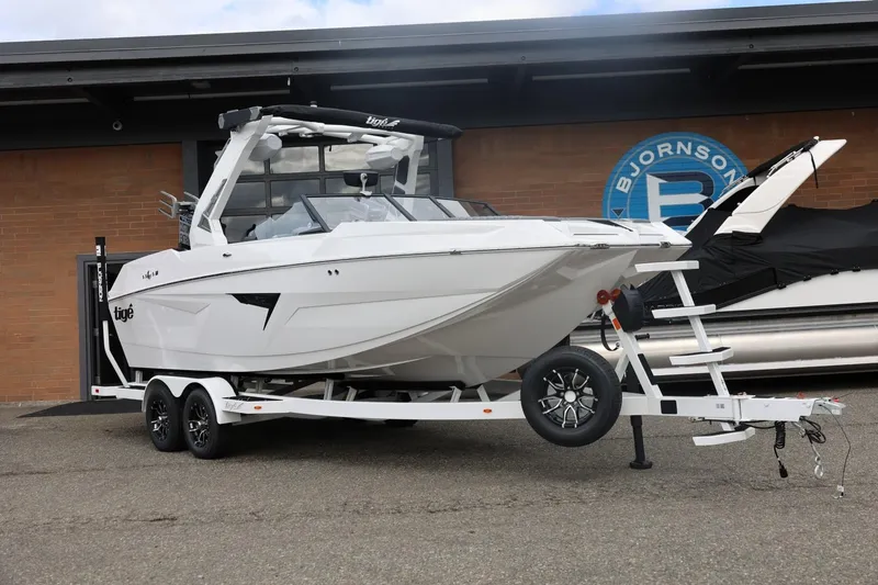 Slide: The Image of 2026 Tigé 22RZX boat on trailer, parked outside Bjornson building. - 4