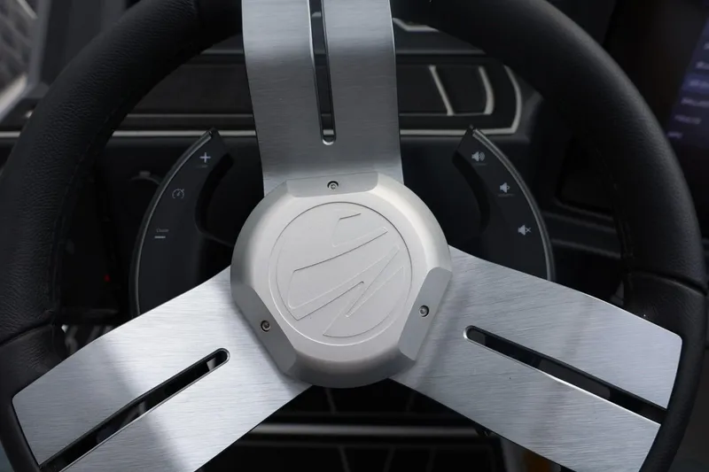 Slide: The Image of Steering wheel of 2026 Tigé 22RZX boat with sleek metallic design. - 40