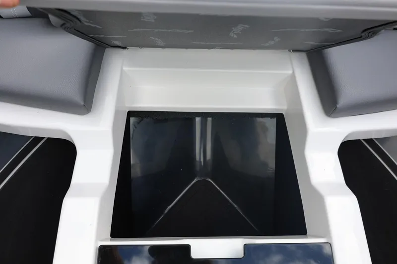 Slide: The Image of 2026 Tigé 22RZX boat interior storage compartment with gray seating. - 48