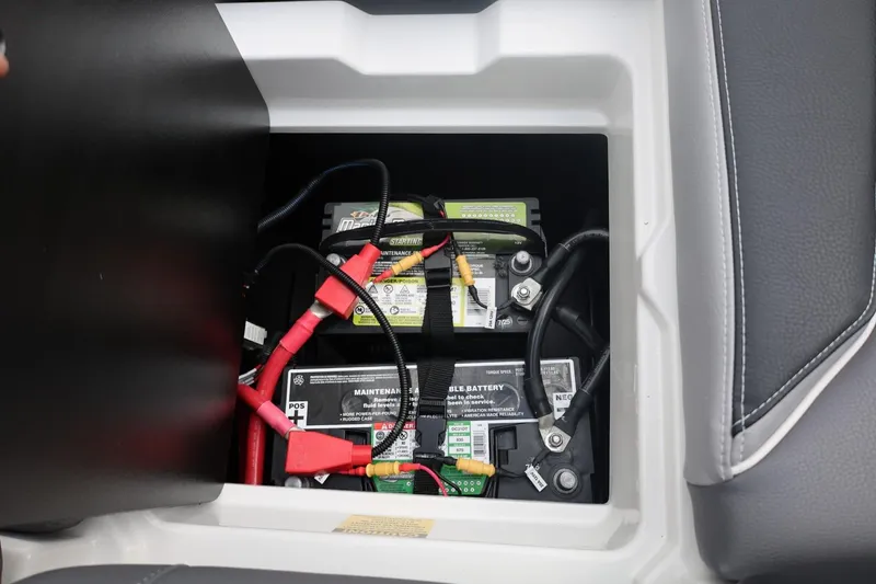 Slide: The Image of Battery compartment of 2026 Tigé 22RZX boat with visible wiring and connections. - 49