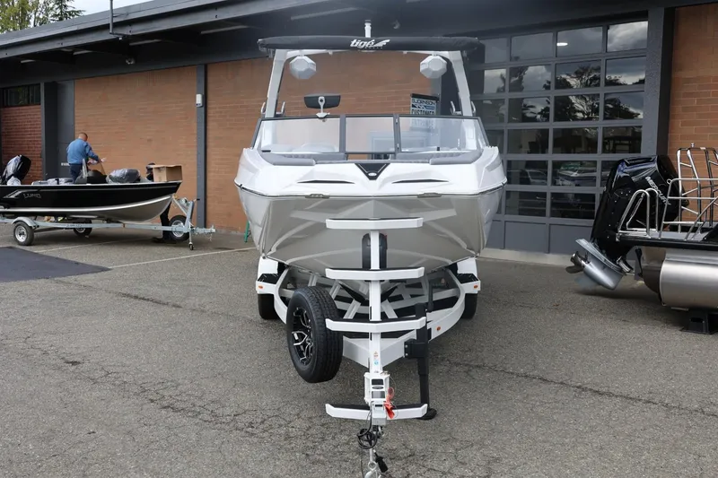 Slide: The Image of 2026 Tigé 22RZX boat on trailer outside a building. - 5