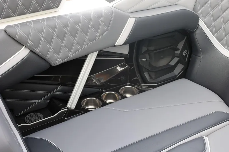 Slide: The Image of 2026 Tigé 22RZX interior with diamond-stitched upholstery and built-in cup holders. - 55