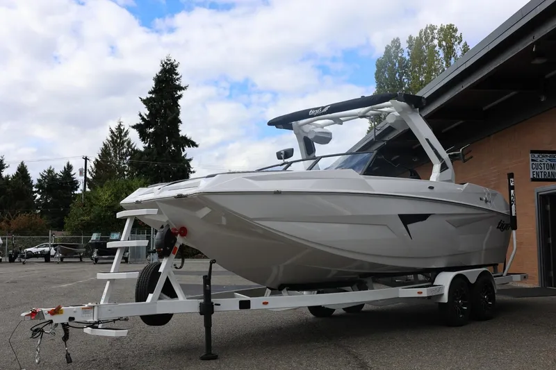 Slide: The Image of 2026 Tigé 22RZX boat on trailer, parked outdoors near building. - 8
