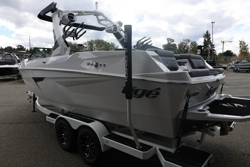 Slide: The Image of 2026 Tigé 22RZX boat on trailer, sleek design, parked outdoors. - 9