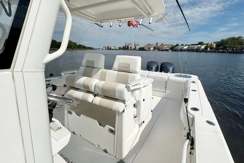 Slide: The Image of 2012 Everglades 325 Center Console boat on a calm river with cityscape background. - 15