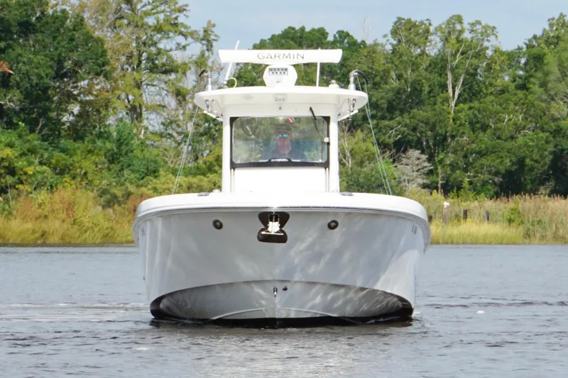 Slide: The Image of 2012 Everglades 325 Center Console boat on water, surrounded by lush greenery. - 4