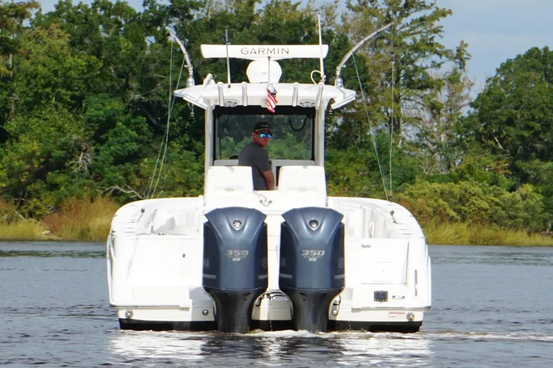 Slide: The Image of 2012 Everglades 325 Center Console boat with dual engines on a calm waterway. - 5