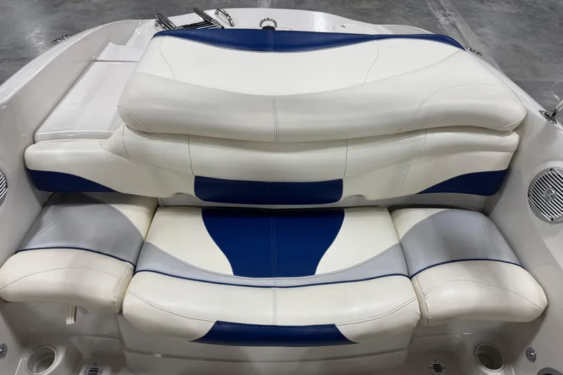 Slide: The Image of 2009 Tahoe Q5i boat interior with blue and white cushioned seating. - 12