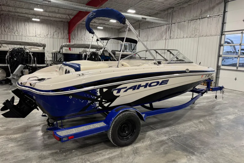 Slide: The Image of 2009 Tahoe Q5i boat on trailer in indoor showroom setting. - 3