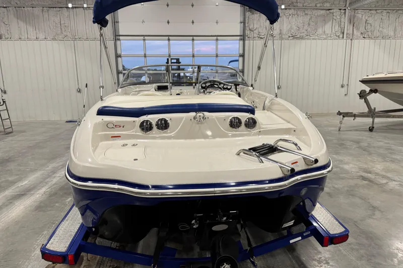 Slide: The Image of 2009 Tahoe Q5i boat in a garage, rear view with blue accents. - 5