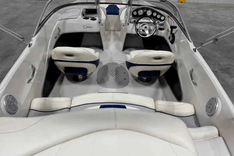 Slide: The Image of 2009 Tahoe Q5i boat interior with white and blue seating, steering wheel, and dashboard controls. - 6
