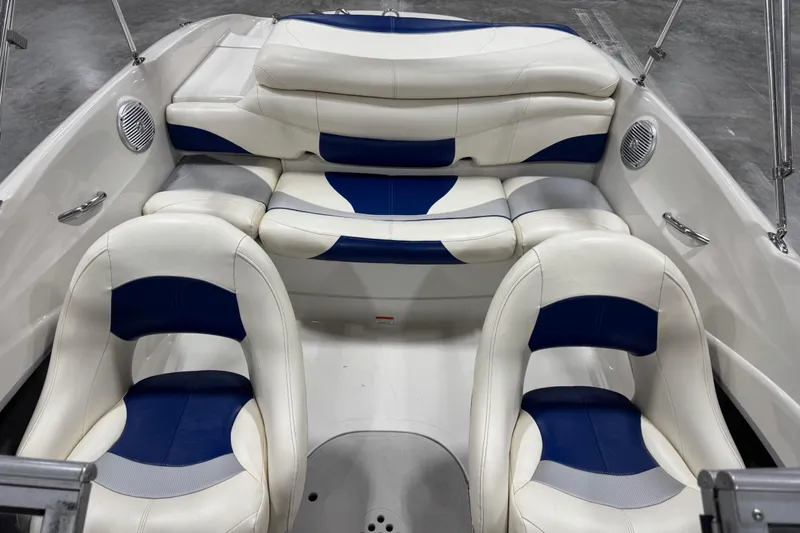 Slide: The Image of 2009 Tahoe Q5i boat interior with white and blue seating arrangement. - 8