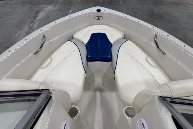Slide: The Image of 2009 Tahoe Q5i boat interior with white and blue seating, stainless steel handles. - 9