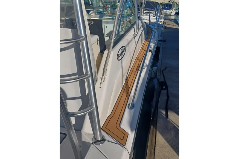 Slide: The Image of 2006 Rampage 33 Express boat docked, featuring sleek design and sturdy railings. - 6