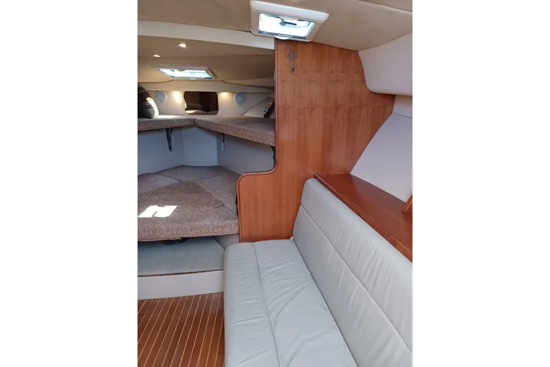 Slide: The Image of 2006 Rampage 33 Express cabin interior with seating and wooden accents. - 15