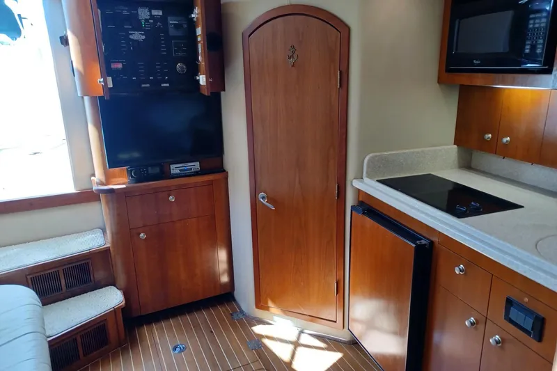 Slide: The Image of Interior of 2006 Rampage 33 Express boat with kitchenette and wooden cabinetry. - 11