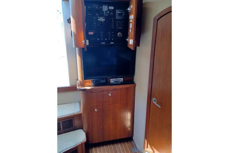 Slide: The Image of 2006 Rampage 33 Express interior with wooden cabinetry and control panel. - 13