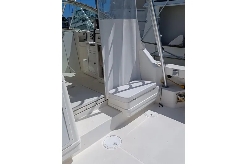 Slide: The Image of 2006 Rampage 33 Express boat interior with seating and helm area. - 8
