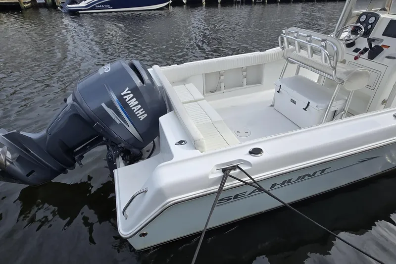 Slide: The Image of 2008 Sea Hunt Ultra 232 boat on trailer, parked near a house, with a "For Sale" sign. - 1